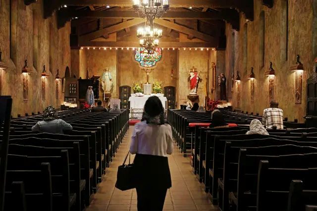 Parishioners enter the church